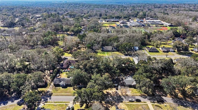 drone / aerial view featuring a residential view and a view of trees