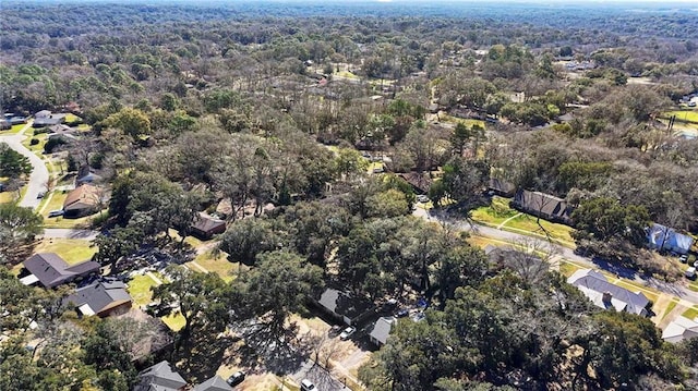 drone / aerial view featuring a forest view and a residential view