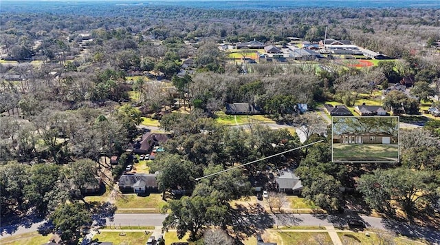 drone / aerial view featuring a residential view and a forest view