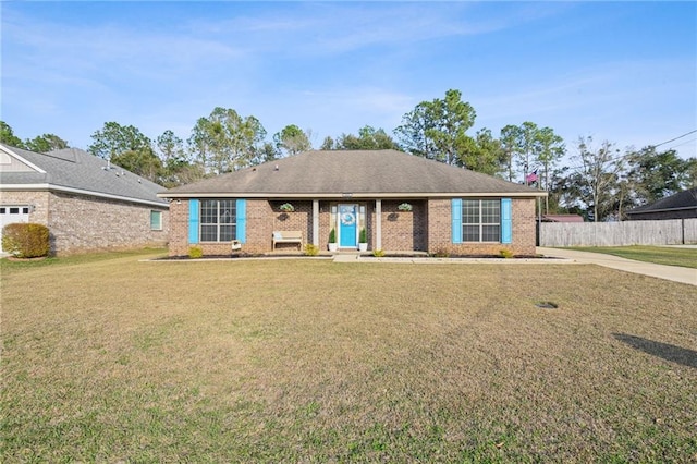 single story home with a front lawn, fence, and brick siding