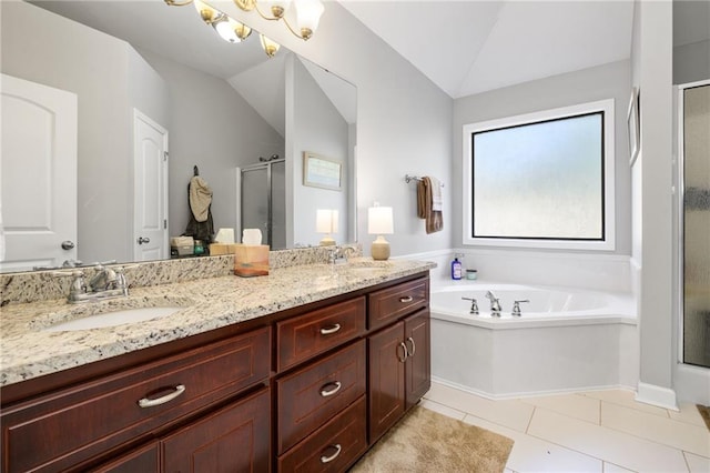 full bathroom featuring double vanity, lofted ceiling, a garden tub, a shower stall, and a sink