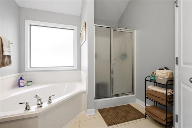 bathroom featuring a stall shower, a garden tub, and tile patterned floors