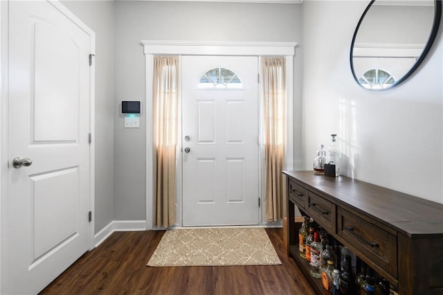 entrance foyer with dark wood-style flooring and baseboards