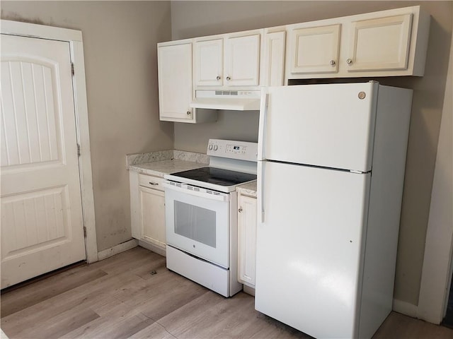 kitchen with light wood-type flooring and white appliances