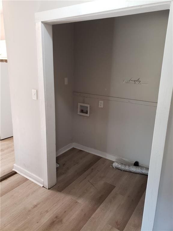 washroom featuring hookup for a washing machine and light hardwood / wood-style flooring