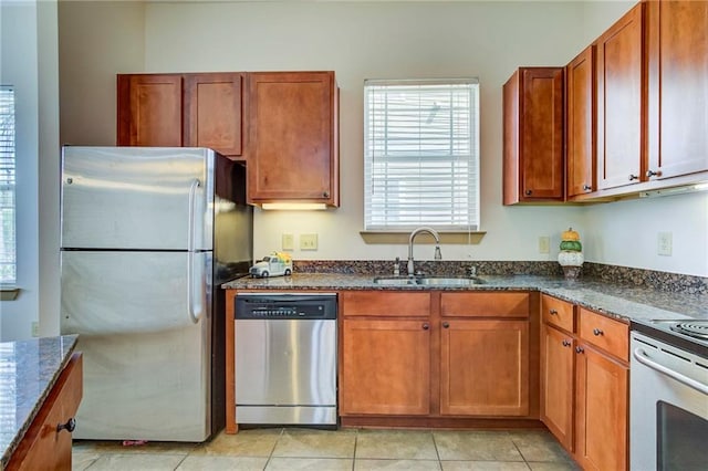 1430 Regency Rd Unit F204, Gulf Shores, AL 36542 - kitchen with stainless steel appliances, a sink, dark stone counters, and brown cabinets