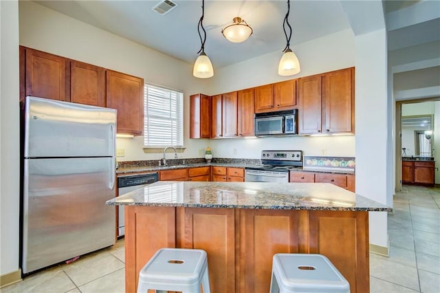1430 Regency Rd Unit F204, Gulf Shores, AL 36542 - kitchen with stainless steel appliances, light tile patterned flooring, and dark stone counters