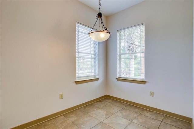 1430 Regency Rd Unit F204, Gulf Shores, AL 36542 - spare room with healthy amount of natural light, baseboards, and light tile patterned floors
