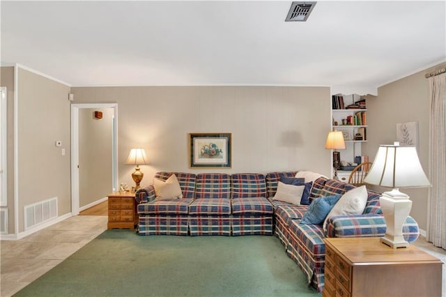 carpeted living area featuring visible vents, crown molding, and baseboards