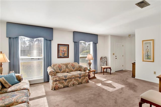 carpeted living room featuring baseboards and visible vents