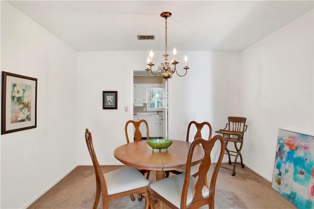 dining area featuring visible vents, light carpet, a notable chandelier, and baseboards