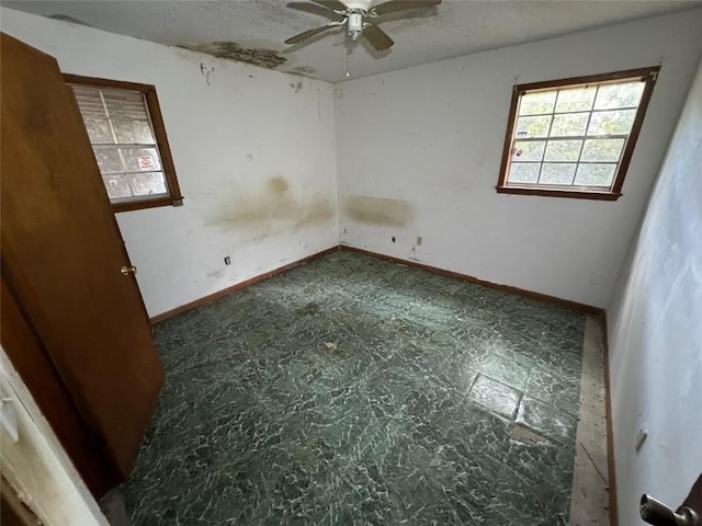 unfurnished room with ceiling fan