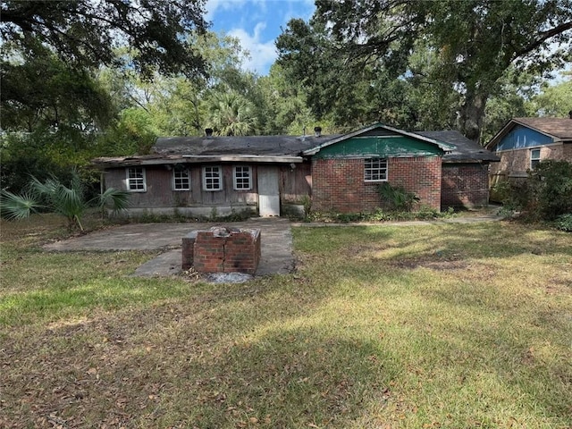 back of house with a patio area and a lawn