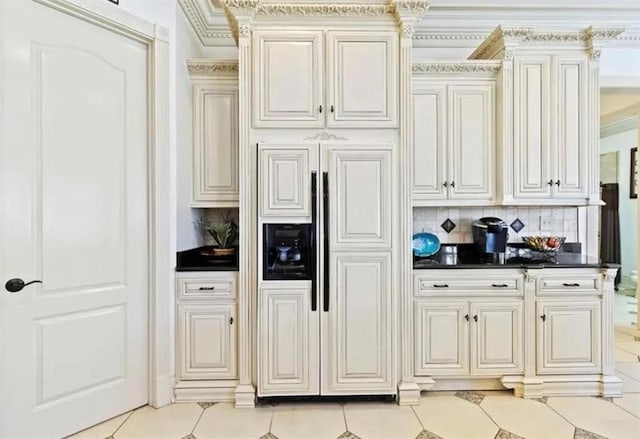 kitchen with light tile patterned floors, dark countertops, paneled refrigerator, and decorative backsplash