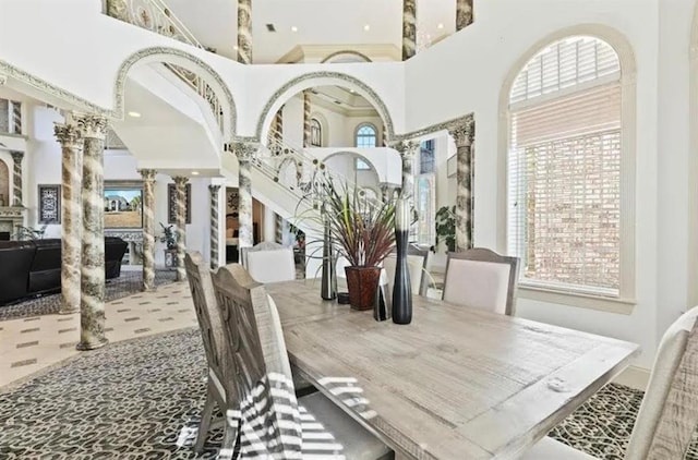 dining room with a high ceiling and ornate columns