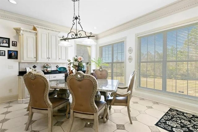 dining area with crown molding, baseboards, and recessed lighting