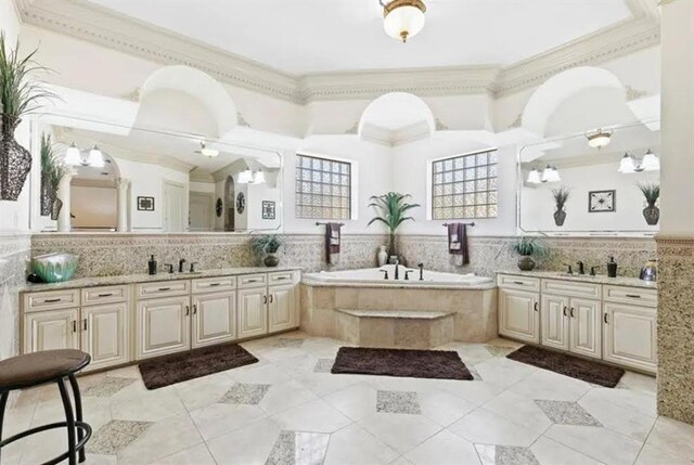 full bathroom featuring a bath, a sink, crown molding, and two vanities