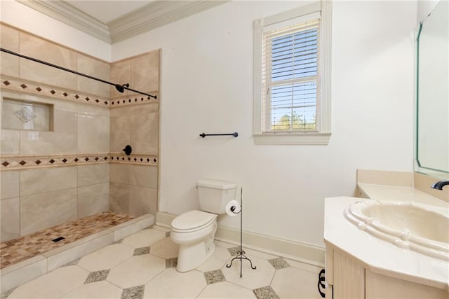 full bathroom with ornamental molding, toilet, a tile shower, and vanity