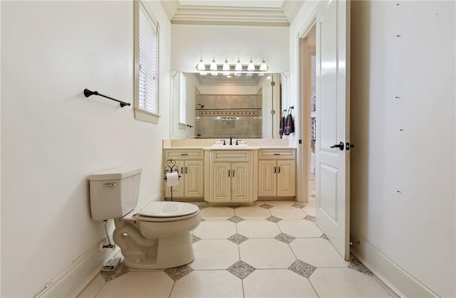 full bathroom with crown molding, toilet, tiled shower, vanity, and baseboards