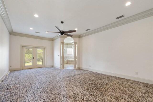unfurnished room featuring visible vents, crown molding, ornate columns, carpet floors, and french doors