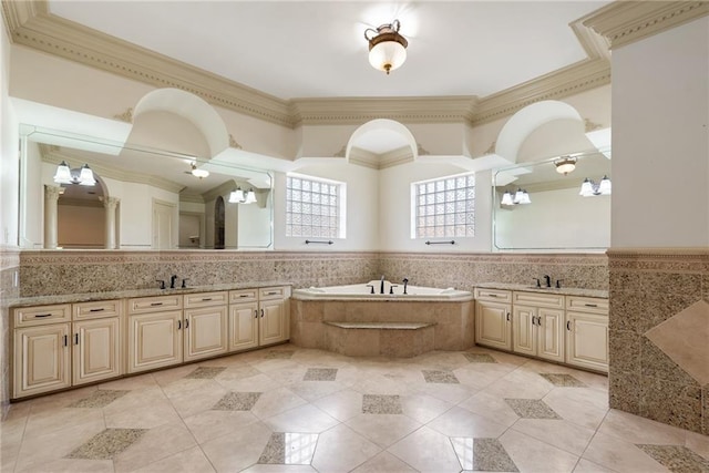 full bath with a sink, ornamental molding, and a garden tub