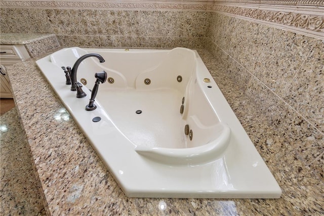bathroom with a tub with jets