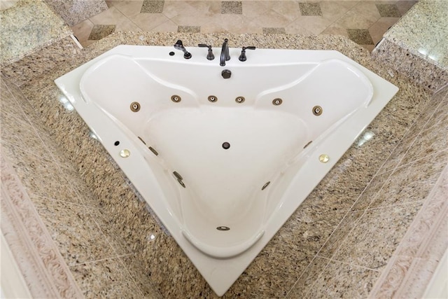 bathroom featuring a tub with jets