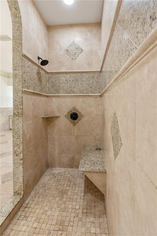 full bathroom with tiled shower