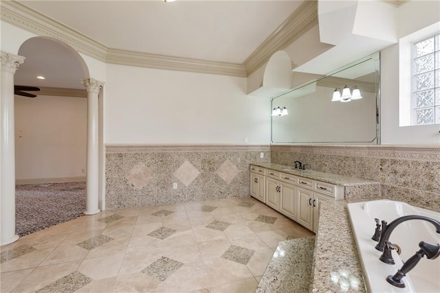full bath featuring tile walls, a wainscoted wall, ornamental molding, decorative columns, and tile patterned flooring