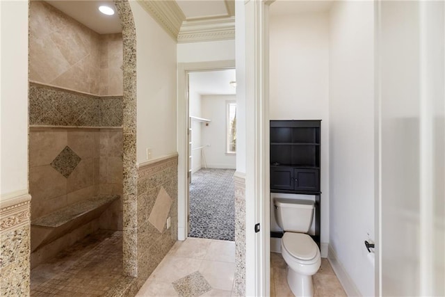 bathroom featuring tile walls, walk in shower, ornamental molding, toilet, and tile patterned floors