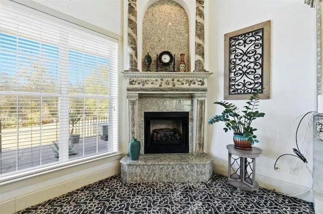 living room with baseboards and a premium fireplace