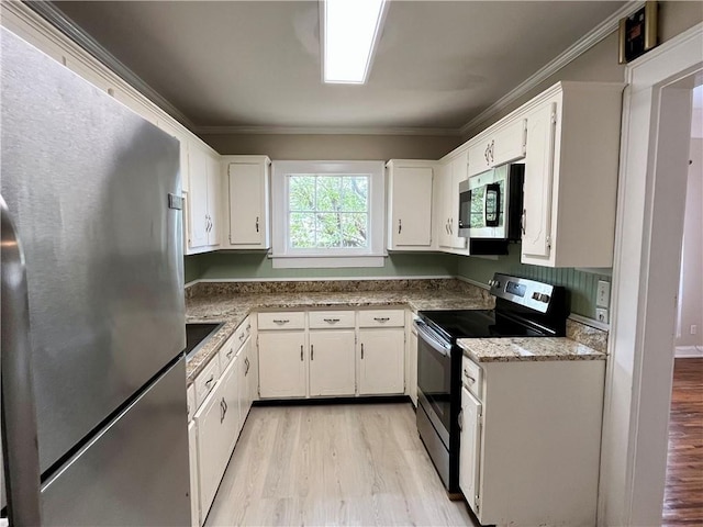 kitchen featuring white cabinets, light wood-style flooring, and stainless steel appliances