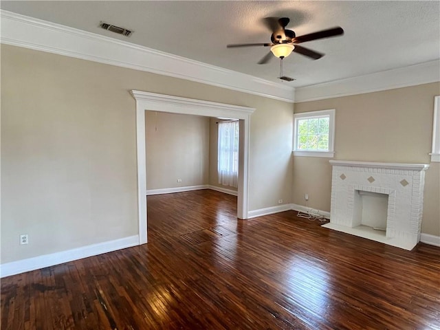 unfurnished living room featuring baseboards, wood-type flooring, visible vents, and a brick fireplace