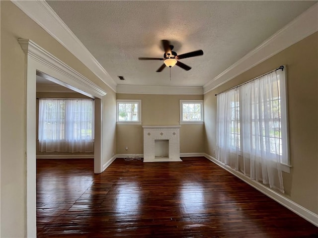 unfurnished living room featuring baseboards, visible vents, hardwood / wood-style flooring, crown molding, and a fireplace