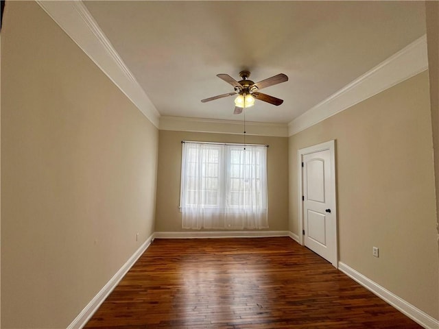 empty room featuring ornamental molding, ceiling fan, dark wood-type flooring, and baseboards