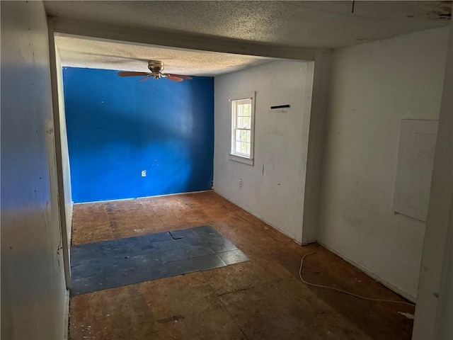 unfurnished room featuring a textured ceiling and ceiling fan