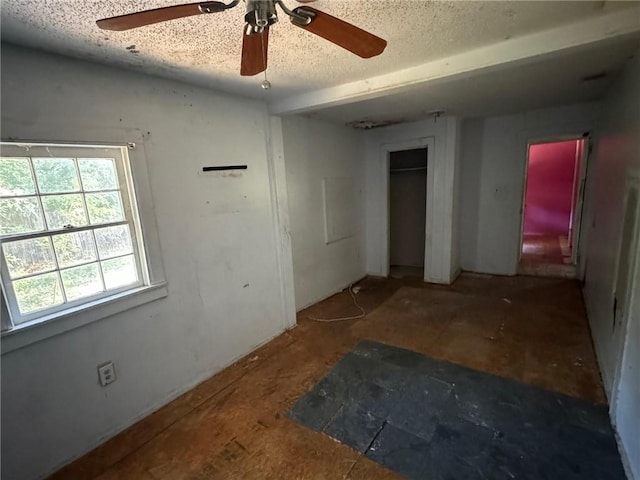 bedroom with a textured ceiling and ceiling fan