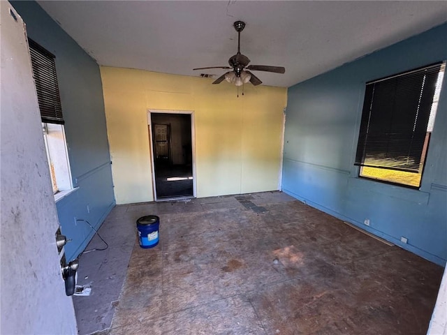 unfurnished room with ceiling fan and a healthy amount of sunlight