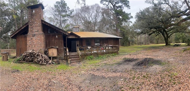 back of property with a chimney