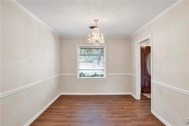 empty room featuring a chandelier, crown molding, and dark hardwood / wood-style flooring