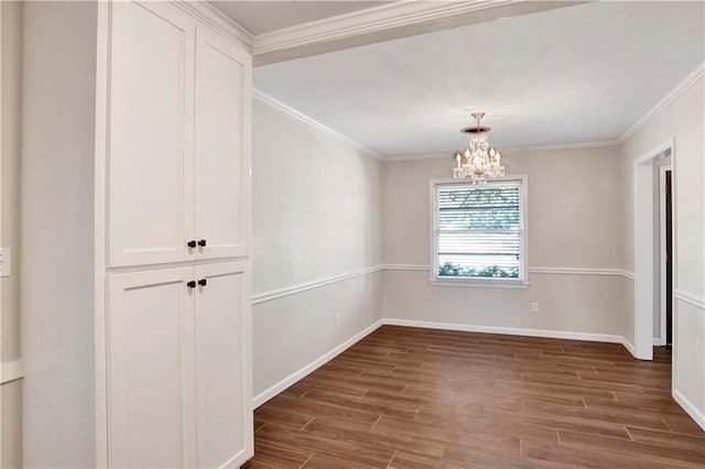 unfurnished room with crown molding, a chandelier, and dark hardwood / wood-style flooring