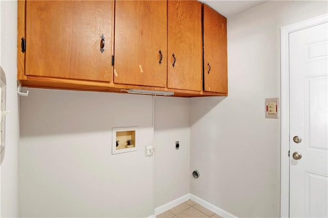 washroom featuring cabinets, hookup for a washing machine, light tile patterned floors, and electric dryer hookup