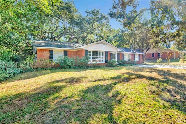 ranch-style home featuring a front yard