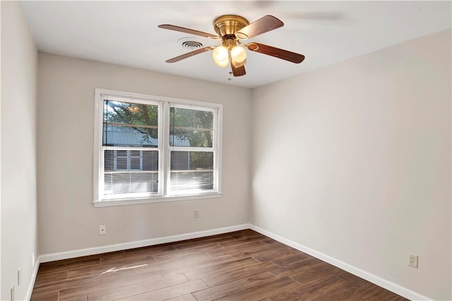 empty room with ceiling fan and dark hardwood / wood-style flooring