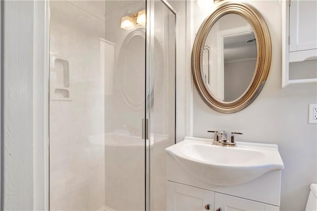 bathroom featuring vanity, a shower with shower door, and toilet