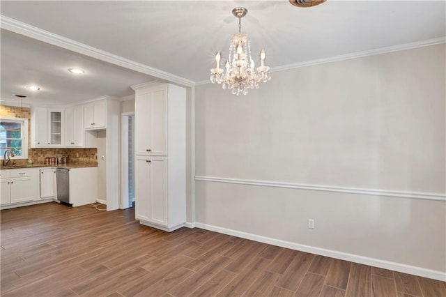 kitchen featuring stainless steel dishwasher, white cabinets, a notable chandelier, and wood-type flooring