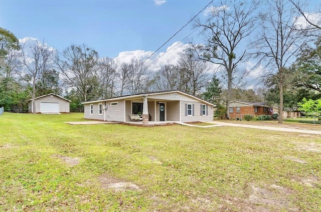 view of front of house featuring a front lawn, a garage, and an outdoor structure