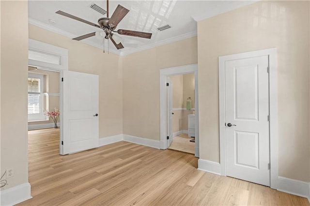unfurnished bedroom with ornamental molding, light wood-style floors, visible vents, and baseboards
