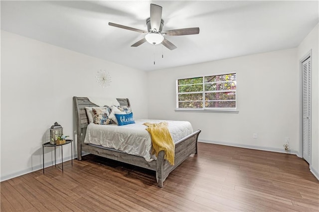 bedroom featuring a closet, hardwood / wood-style flooring, and ceiling fan