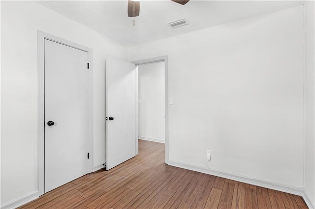 unfurnished bedroom with ceiling fan and light wood-type flooring